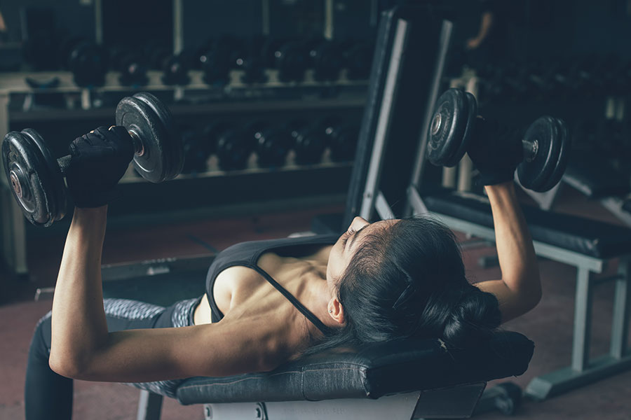 beautiful-asian-woman-lifting-weights-dumbbell